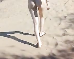 Youthfull woman ambling bare in public beach