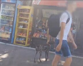 MILFA walks topless through town.