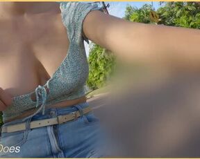 A girl on a bike shows her breasts as she rides