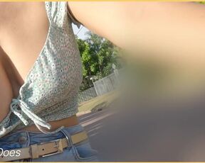 A girl on a bike shows her breasts as she rides