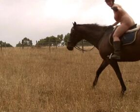 Naked lady rubbing her Boobs Riding a horse