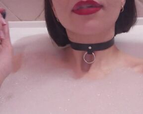 Smoking beauty lying in the bathtub flashing her tits