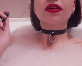 Smoking beauty lying in the bathtub flashing her tits