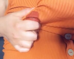 A fat woman in an orange blouse. Lactation through clothes and display of large milk boobs