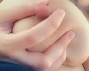 She squeezes jets of her milk out of her nipple