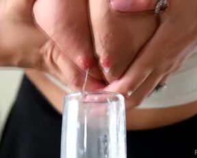 A beautiful scene of lactation close-up ( in a glass). Gorgeous blonde is jerking off her milky tits