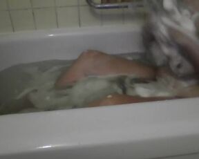It's just a neighbor washing her bathtub. Rubbing foam on her tits.