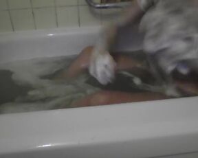 It's just a neighbor washing her bathtub. Rubbing foam on her tits.