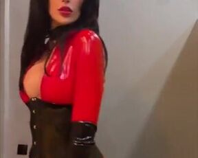 Domme flaunts in front of a mirror