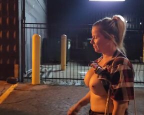 Dame ambles down street bare-breasted