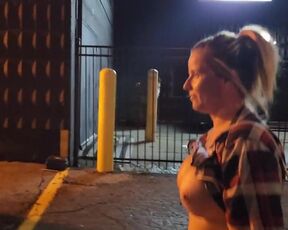 Dame ambles down street bare-breasted