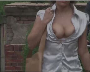 Sitting in a cafe, a hot brunette flashes her huge boobs