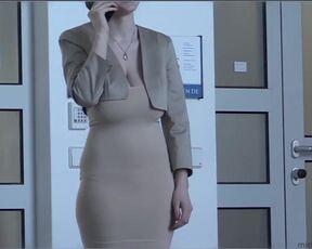 She covers her huge breasts with her hand and talks on the phone. Do you notice her nipple