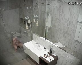 Busty girl washes and shaves in a large shower room