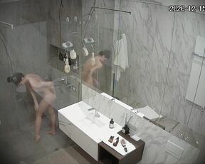 Busty girl washes and shaves in a large shower room