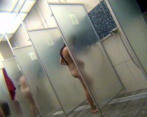 Shared showers. Girls and women washing themselves coming out of the pool