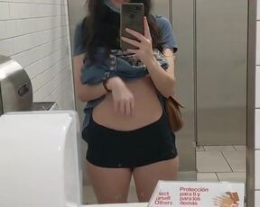 Topless in a public restroom. Forbidden tiktok content