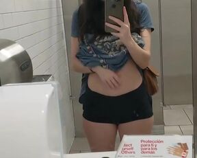 Topless in a public restroom. Forbidden tiktok content