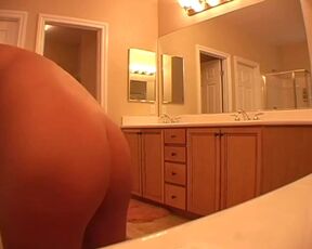 Naked girl drying her hair in a hotel room