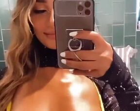 Oily boobs in the reflection of mirror