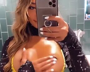 Oily boobs in the reflection of mirror