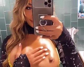 Oily boobs in the reflection of mirror