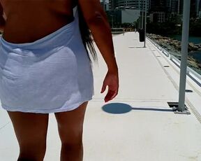 Summer walk in the city flashing her tits from under her shirt