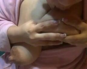 Amateur Mummy commences stroking her sagging juggs out of her thick lactating nips while in a building bathrobe