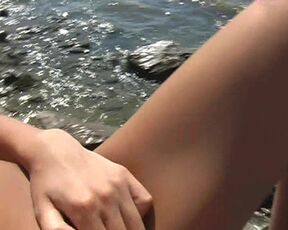 Topless girl in a bikini on the beach. Public masturbation.