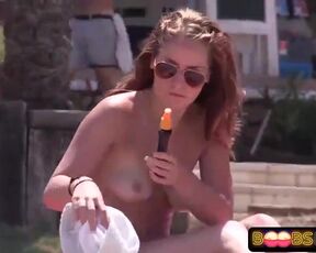 Saucy light-haired is liking without bra on the beach while people are secretly taking pictures of her