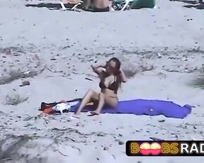 Large jugged dark haired took off her top on the beach, wanting her titties to suntan a bit