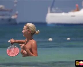 Bare-Chested damsel doesn't give a sex that everyone is gawping at her boobies, on the beach