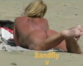 Bare duo is making enjoy on the naturist beach, in the middle of the day