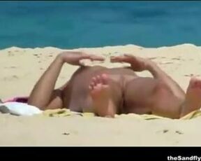 Bare duo is making enjoy on the naturist beach, in the middle of the day