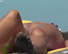 Nude dame is loving on a naturist beach and opening up up to showcase her shaven beaver