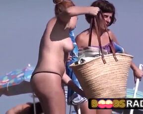 Suntanned nymphs are entirely nude on the beach not knowing that someone is making vids of them