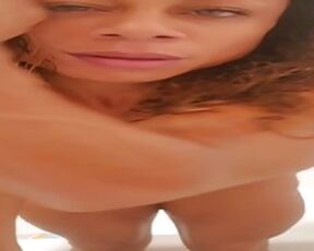 Black lady with phat tits is kneading her ideally shaven pussy in the bathroom