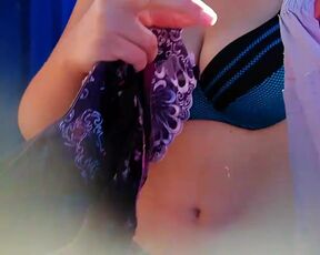 Busty, bespectacled student changes her clothes in a stall on the beach