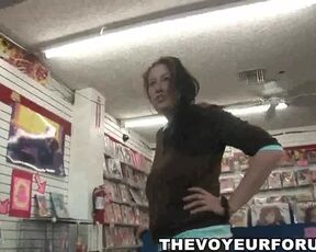 Busty babe bares it all at the porn store