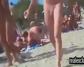 Horny voyeur is watching, while horny couples are having sex on the public nude beach