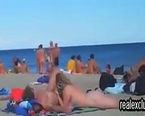 Horny voyeur is watching, while horny couples are having sex on the public nude beach