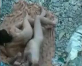 Delicious voyeur sex on a rocky beach captured by a guy who hid himself well