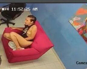 Cute brunette is sitting and rubbing her warm pussy, while a voyeur is making a video